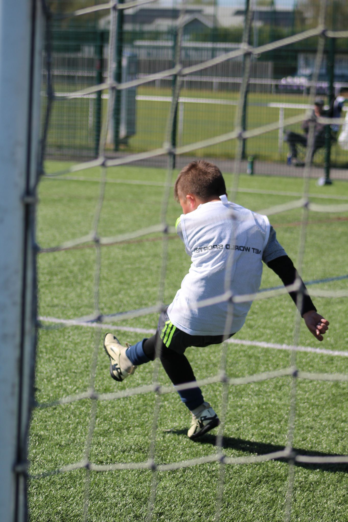 Young boy taking a goal kick during JCSS football coaching in Skegness