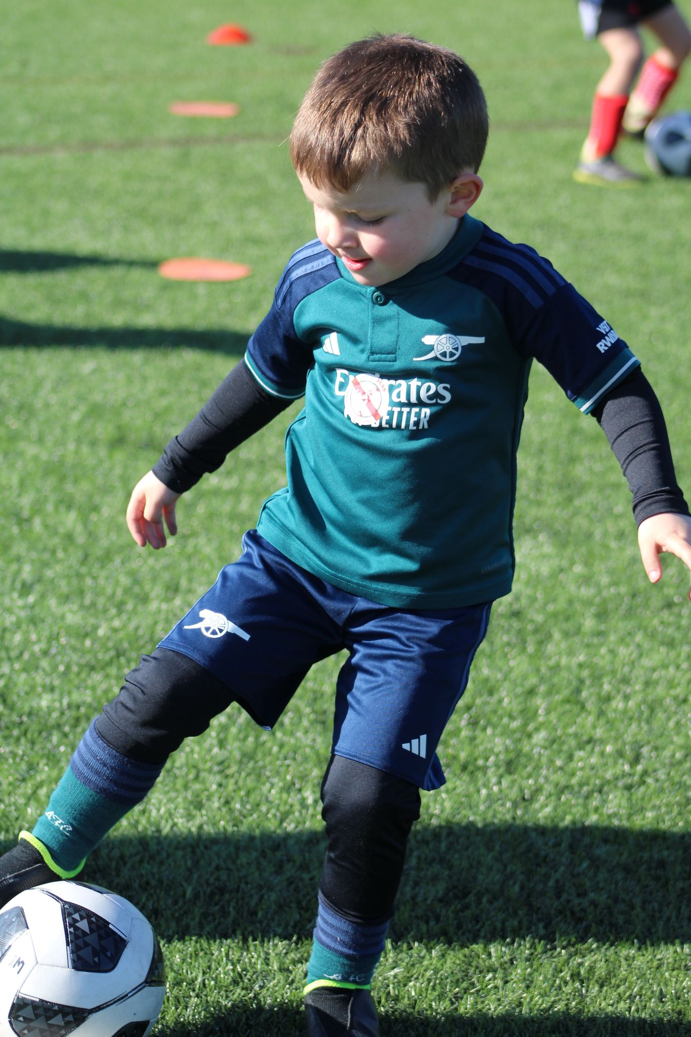 football holiday camp in skegness - child playing football and doing a skill