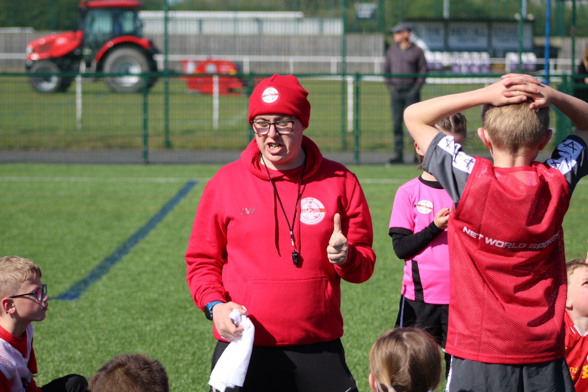 Coach Jack facing forward, giving football instructions to a group of children at JCSS in Skegness