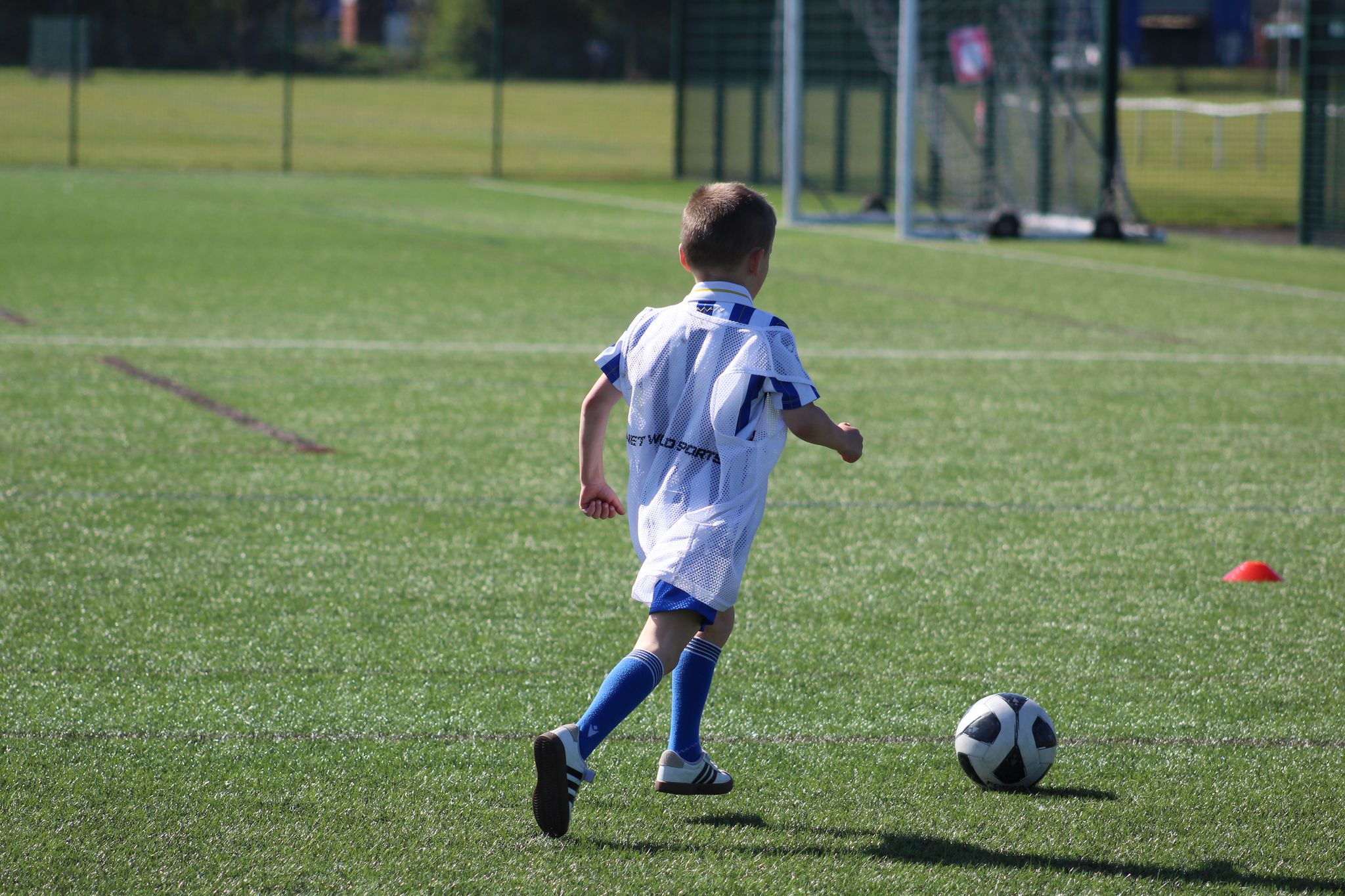 Young child dribbling in Playmakers session at JCSS in Skegness