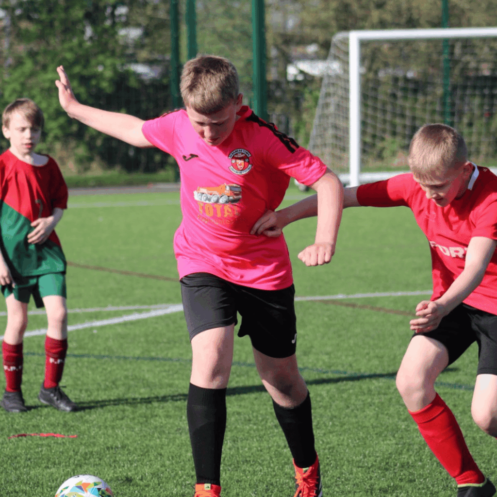 child taking on defenders at jcss development+ soccer school
