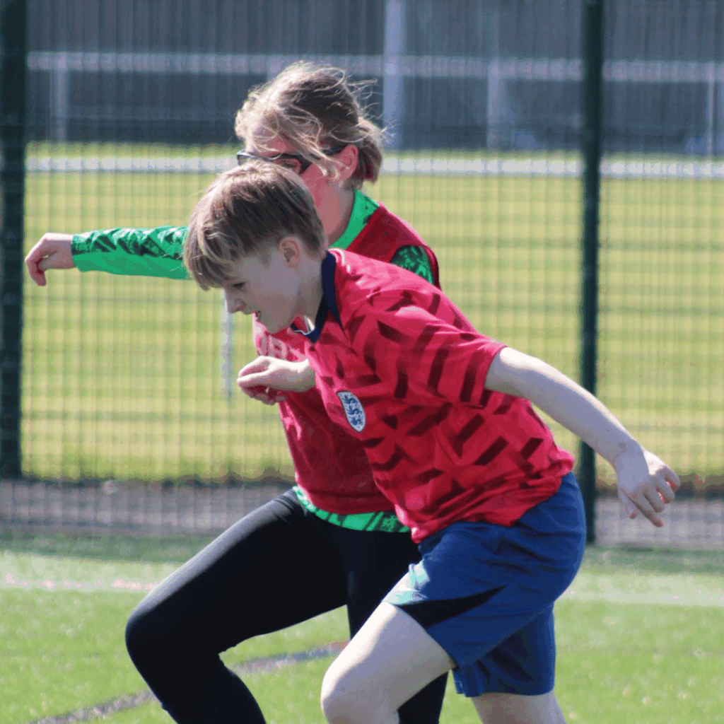 two children running for the ball at jcss development+ in skegness