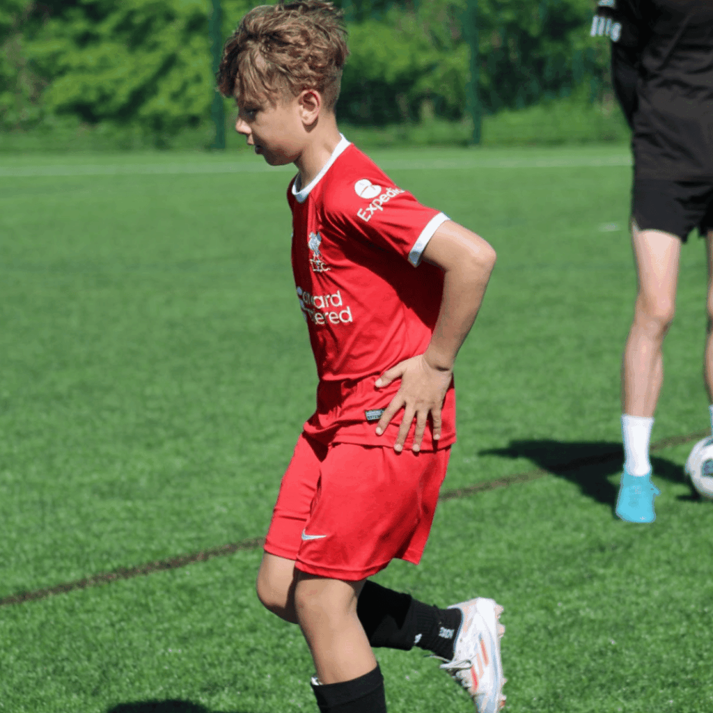 child dribbling the ball after doing a skill in jcss development+ in skegness