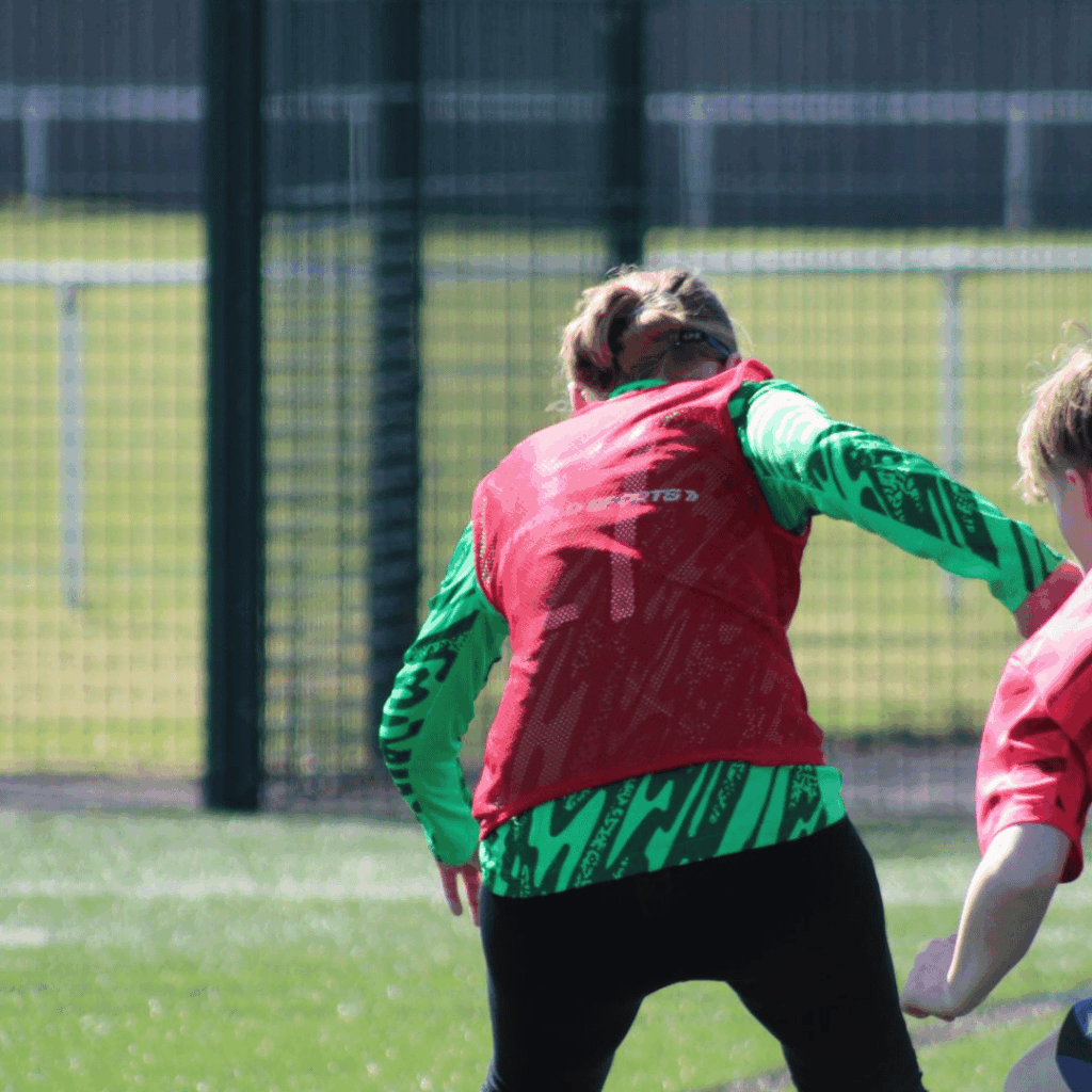 photo of a girl taking on a defender in the JCSS development+ soccer school
