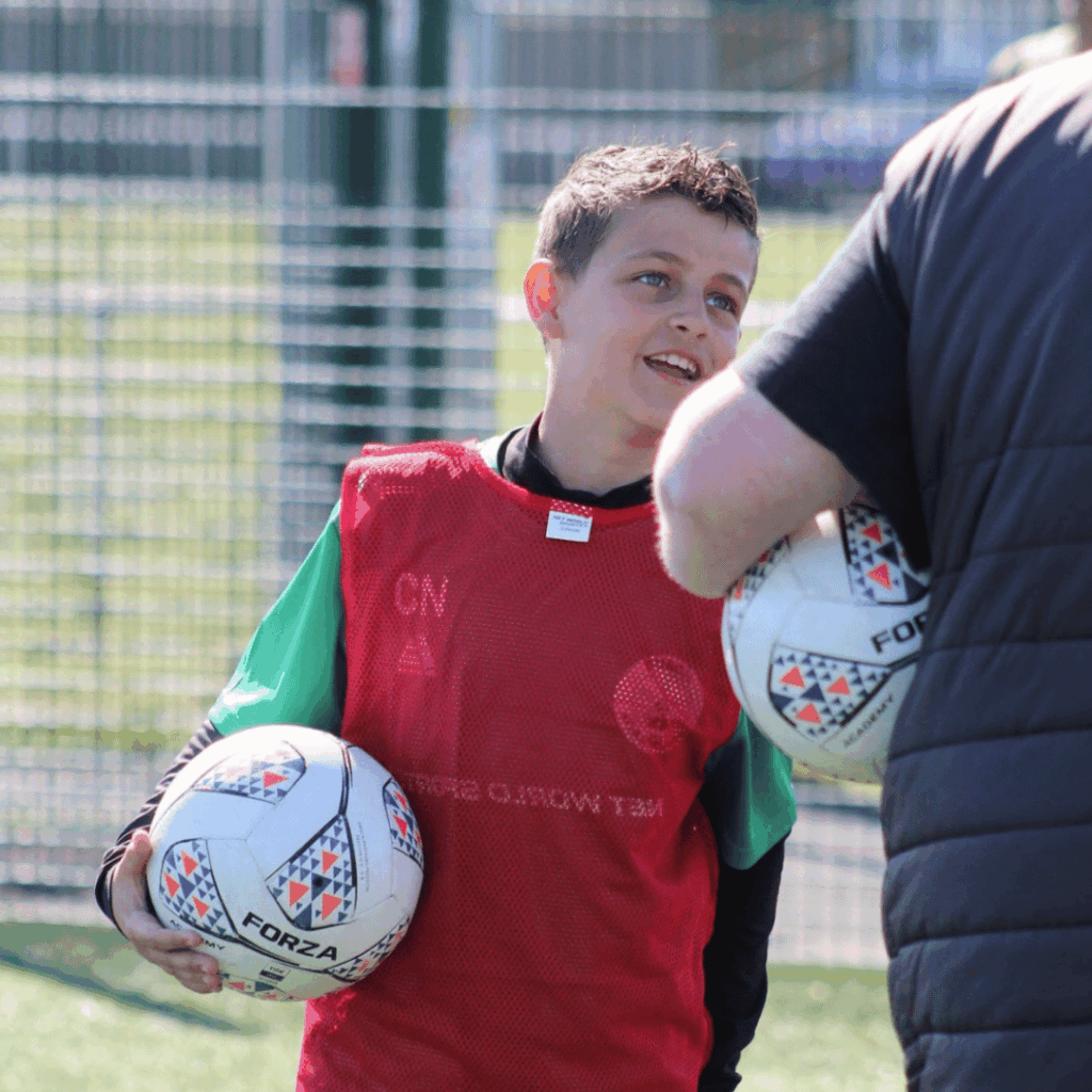 child talking to a coach in the JCSS development+ soccer school