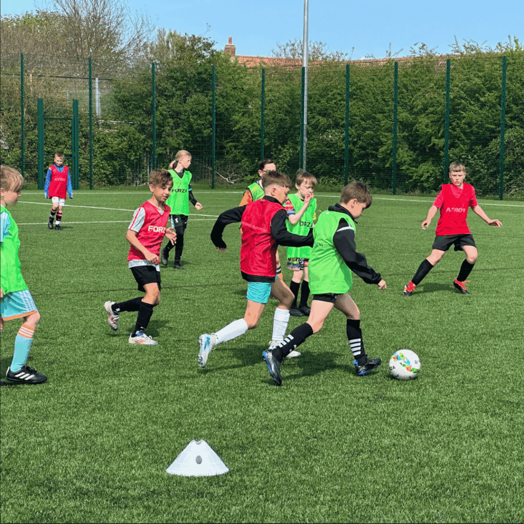 child running past defenders to the goal in jcss development+ soccer school
