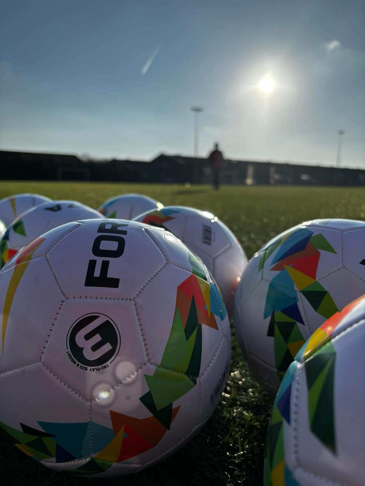 Cinematic close-up of footballs used in JCSS training sessions in Skegness