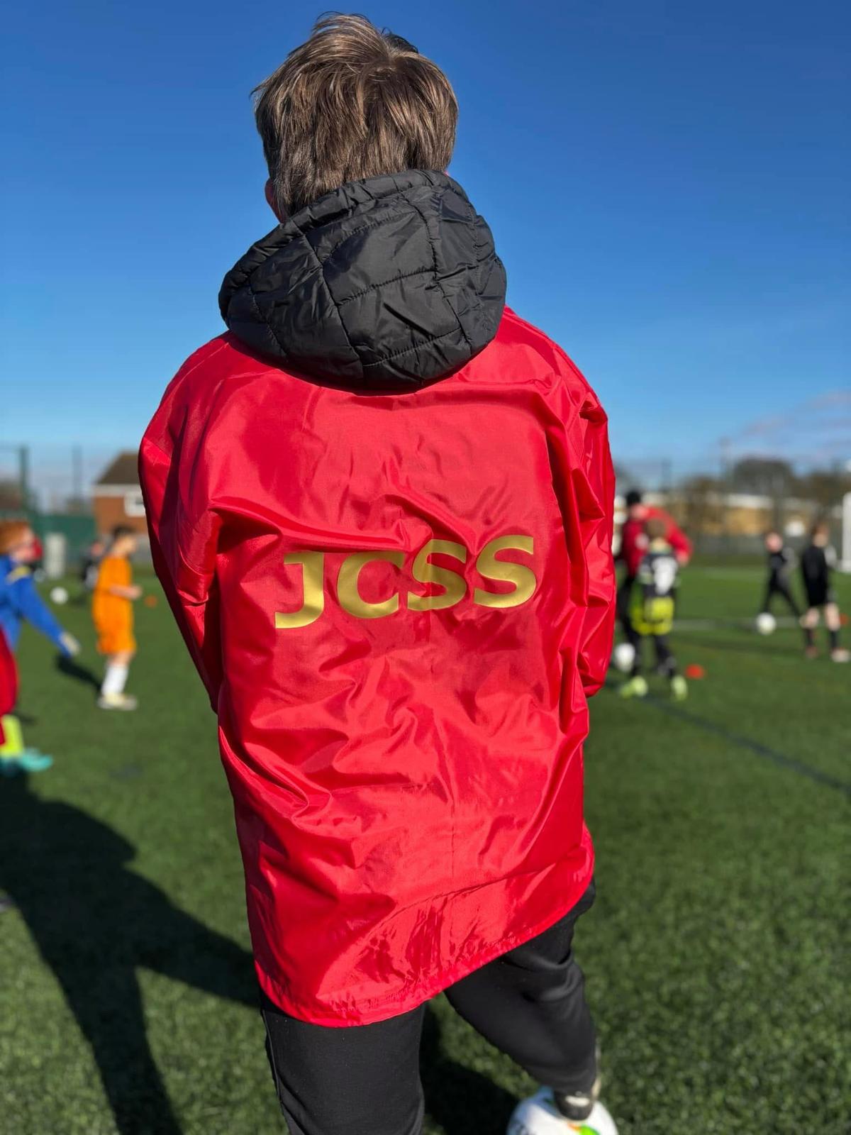 Young football player wearing JCSS jacket in Skegness