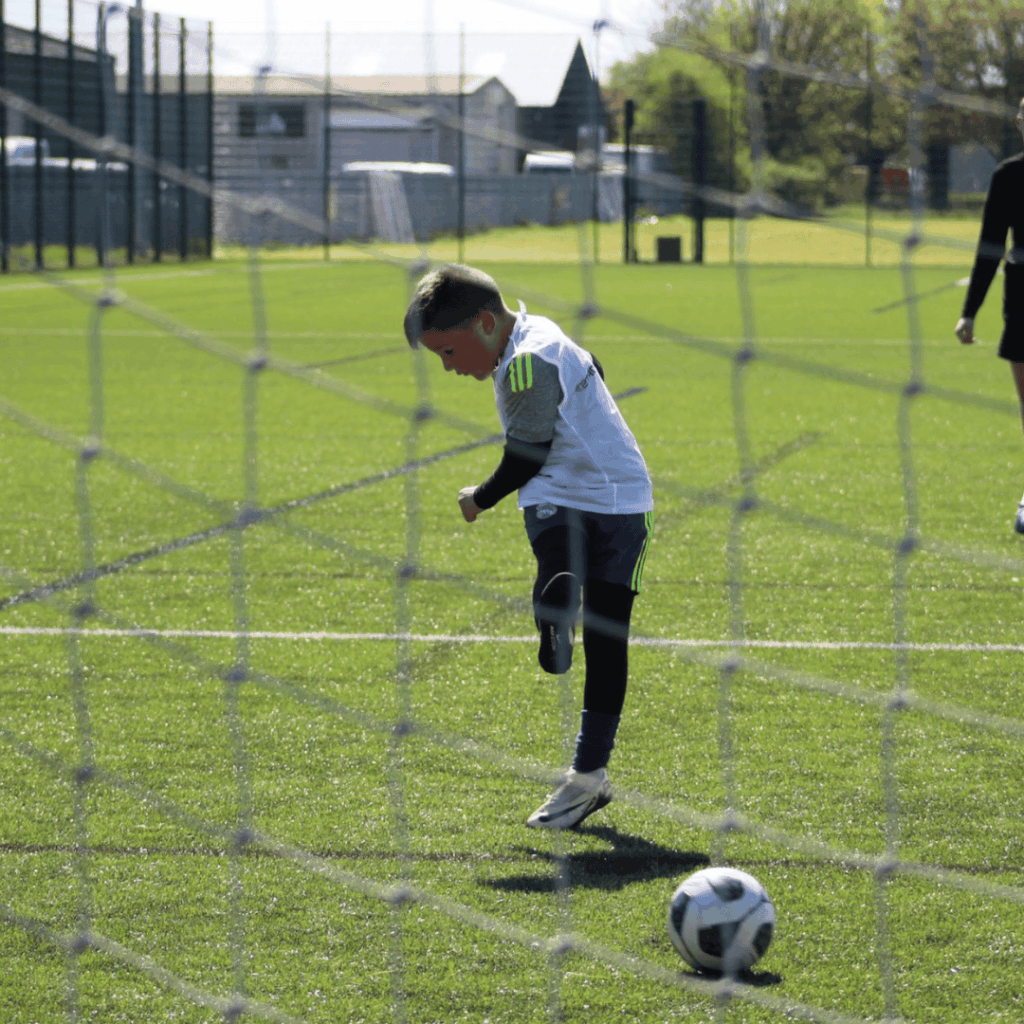 child scoring a goal at JCSS playmakers