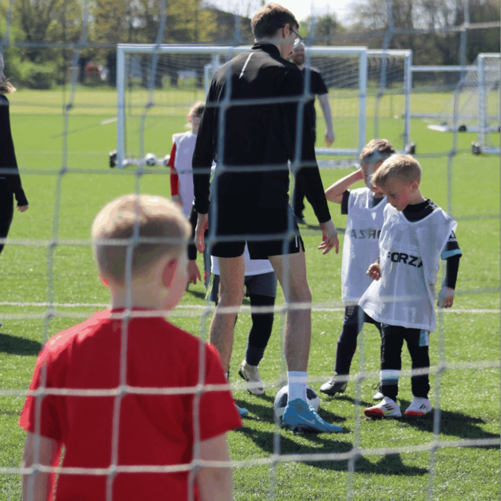 Coach teaching children how to do the next drill at JCSS playmakers holiday camp in skegness