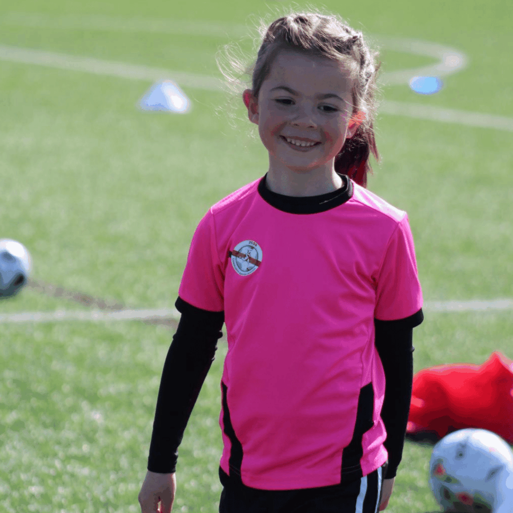 young girl smiling for a photo at the JCSS playmakers soccer school