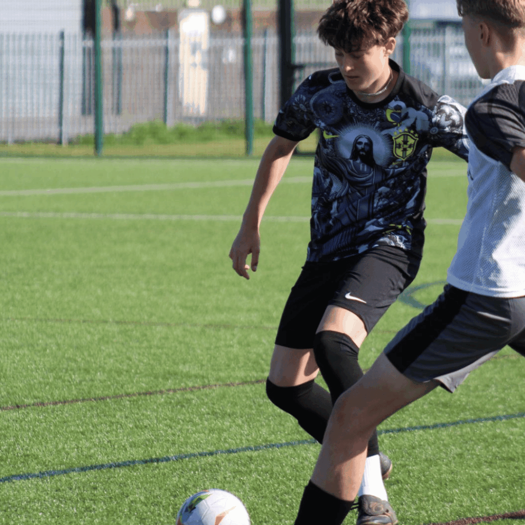 older child doing a skill trying to get round a defender at JCSS development+ in skegness