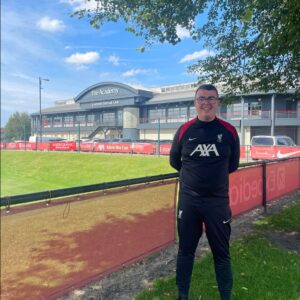Jack standing in front of Liverpool International Academy, where he previously coached