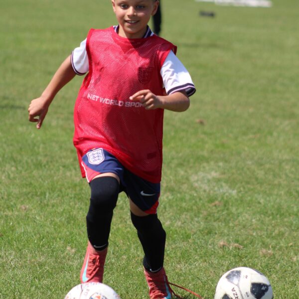 jcss-player-dribbling-red-bib-01